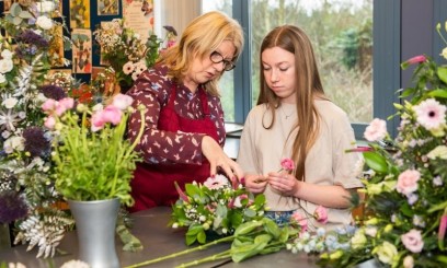 Floristry lecturer working with student in Floristry Cutting Room