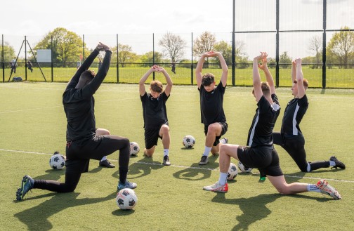 Sports students warming up for football training on our MUGA