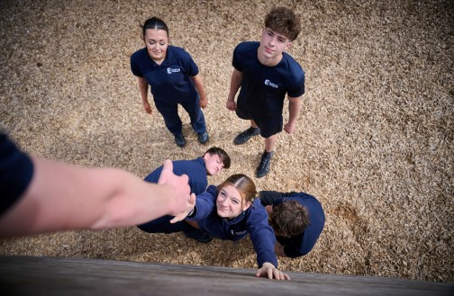 Uniformed Services students using our wooden obstacle wall